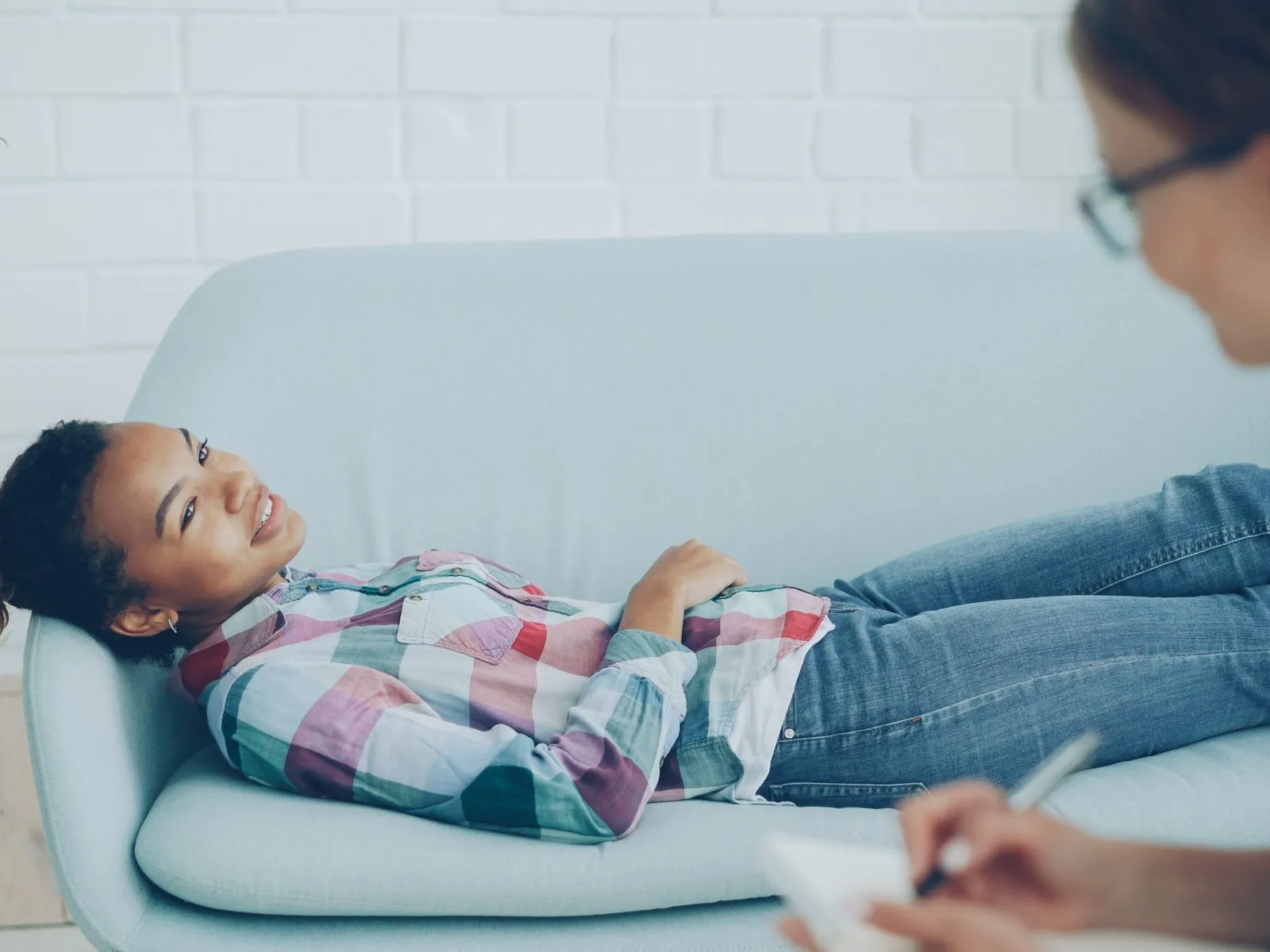 A person smiling while speaking with a counsellor